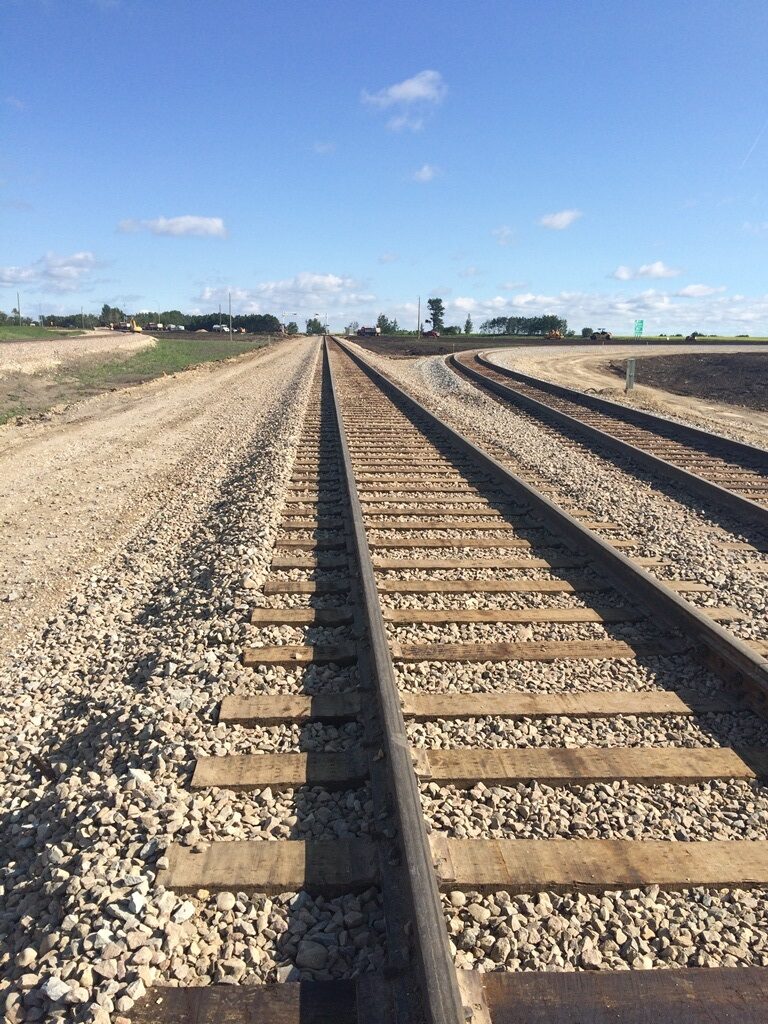 Exterior view of a rail moving toward the horizon and blue sky