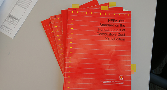 NFPA 652 red manuals stacked on a table