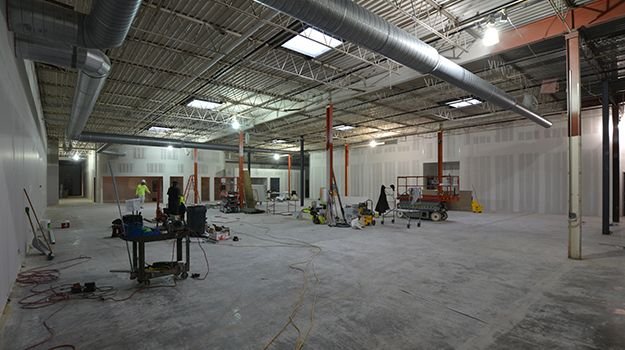 Interior view of office expansion under construction with exposed ceiling