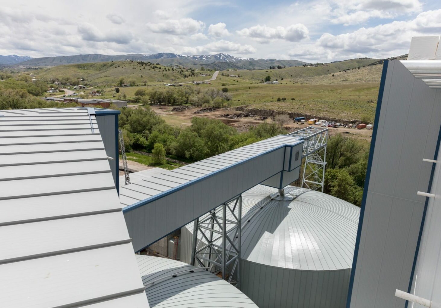 Overhead exterior view of Great Western Malting Facility Expansion with mountains in the distance